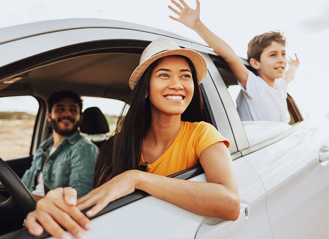 Contact - Portrait of a Cheerful Family with a Young Son Sticking his Hands Out the Window During a Summer Road Trip